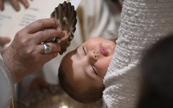 Pope Francis baptizes a baby during Mass in the Sistine Chapel at the Vatican on Jan. 7, 2024, the feast of the Baptism of the Lord. (CNS/Vatican Media)