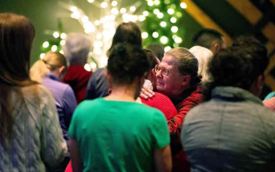 People embrace as worshippers gather at Blackhawk Church in Madison, Wis., Dec. 16, 2024, to pray for victims and survivors of a mass shooting that day at Abundant Life Christian School in Madison. At least three people are dead, including the suspect, and others are injured, after the mass shooting, police said. (OSV News photo/Cullen Granzen, Reuters)