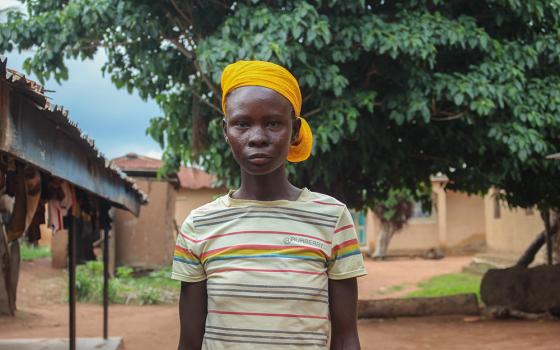 Naanzem Bayawaa, now 20, in front of her parent’s house. She gave birth to her first child at 12 and her second at 15. (GSR photo/Valentine Benjamin)