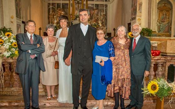 John Campitelli at his wedding in June 2005, with his reunited Italian birth mother, Francesca (in the blue dress), and his American adoptive parents, Barbara and Russell (last two on the right). "It was the first time that my biological family met my adoptive family," he said to NCR. (Courtesy of John Campitelli)