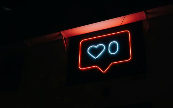 A neon sign with a like count of zero (Unsplash/Prateek Katyal)