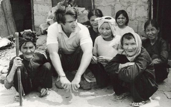 Thomas C. Fox speaks with Vietnamese refugees at the Dong Tac camp in 1967, which offered minimal shelter to several thousand war refugees, situated outside Tuy Hoa, Vietnam. (Courtesy of Thomas C. Fox)