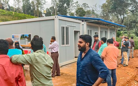 Beneficiaries gather around the temporary houses being handed over to the landslide victims of Wayanad in the southwestern Indian state of Kerala. (Thomas Scaria)