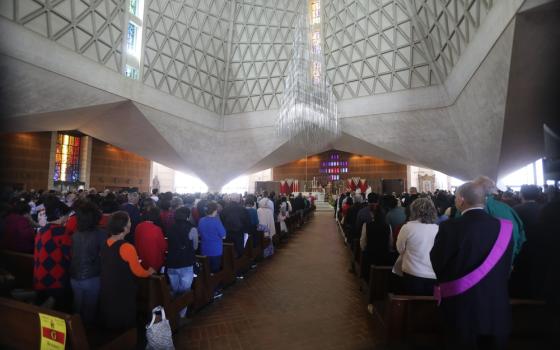 Interior of Cathedral filled with people. 