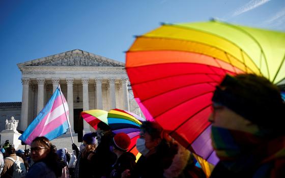 People hold rainbow-colored umbrellas and flags at a demonstration at the U.S. Supreme Court on Dec. 4, 2024. President Donald Trump signed executive orders Jan. 20 that direct the U.S. government to only recognize two sexes, male and female, and another ending diversity, equity and inclusion programs within federal agencies. (OSV News/Reuters/Benoit Tessier)