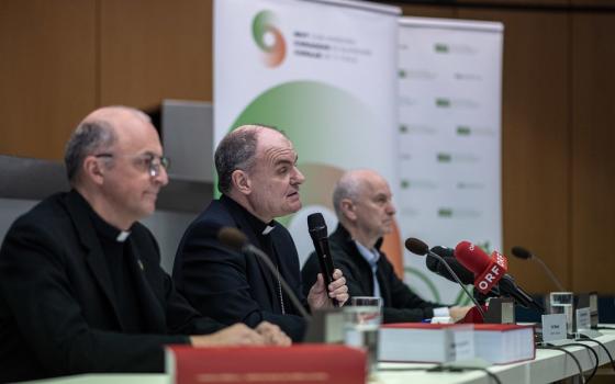 Bishop in middle of panel with other clerics. 