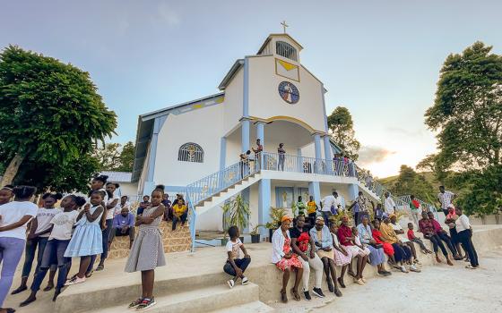 Parishioners of Our Lady of the Assumption Parish in Meyer Grande, Haiti, wait outside their newly built church for services to begin. Parishioners built the structure, with support from members of St. Margaret Mary Catholic Church in Winter Park, Fla. (Courtesy of St. Margaret Mary Church)