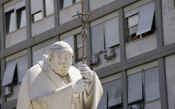 A statue of St. John Paul II is seen outside of Rome's Gemelli hospital June 8, 2023, where Pope Francis is staying after undergoing surgery to treat a hernia June 7. Because of his frequent visits over his three-decade pontificate, the Polish pope affectionately called the hospital "the third Vatican" after his second "home" at the papal summer residence in Castel Gandolfo outside of Rome. (CNS photo/Justin McLellan)