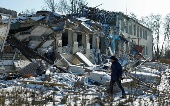 Yurii Bilyk, director of a local lyceum, walks next to the organization's building in Dnipropetrovsk region, Ukraine, Feb. 18, 2025. The structure was destroyed by a recent Russian airstrike.