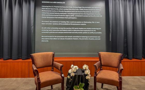 Two empty chairs sit inside Ahmanson Auditorium Feb. 4 at Loyola Marymount University in Los Angeles. Two scheduled conference panels on air quality and environmental justice were canceled after federal workers withdrew from participating due to the Trump administration's directives on diversity programs. (Cecilia González-Andrieu)