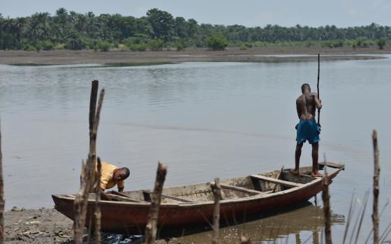 Two fishermen in Bodo city arrive home with no catch after oil spills have affected aquatic life in local communities.