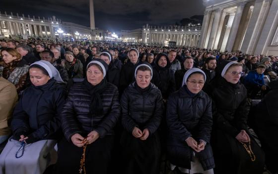 People join Cardinal Víctor Manuel Fernández, prefect of the Dicastery for the Doctrine of the Faith, for the recitation of the rosary for Pope Francis in St. Peter’s Square at the Vatican 