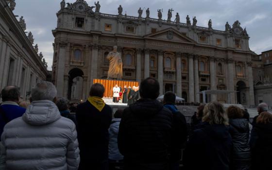 Screen in St. Peter's Square shows clergy saying rosary.