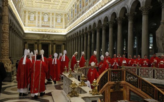 U.S. bishops from Region 13 walk in procession to pray at the tomb of St. Paul after concelebrating Mass at the Basilica of St. Paul Outside the Walls in Rome Feb. 12, 2020, during their "ad limina" visits to the Vatican to report on the status of their d
