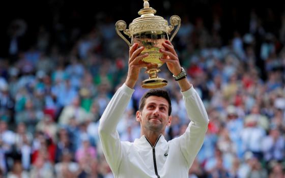 Serbia's Novak Djokovic poses with the Wimbledon trophy in London July 14, 2019, after defeating Switzerland's Roger Federer in five sets. (CNS/Reuters/Andrew Couldridge)