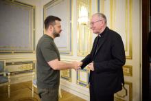 Parolin and Zelenskyy shake hands. 