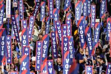 Delegates hold signs as former President Barack Obama speaks during the Democratic National Convention Aug. 20 in Chicago. (AP/Brynn Anderson)