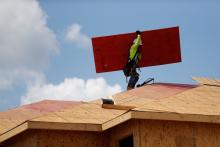 A carpenter works on building new townhomes in Tampa, Fla., May 5, 2021. In a recent NCR poll of Catholic voters in swing states, nearly half — 46% — identified affordable housing as an important issue that will influence their decisions on Election Day. CNS/Reuters/Octavio Jones)