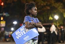 A young girl holds a "Black Voters for Harris-Walz" sign outside of Democratic presidential nominee Vice President Kamala Harris' election night watch party at Howard University, Tuesday, Nov. 5 in Washington. (AP photo/Terrance Williams)