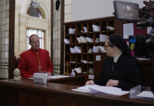 Ralph Fiennes is pictured playing Cardinal Lawrence with Isabella Rossellini as Sister Agnes in a screengrab of behind the scenes footage for director Edward Berger's "Conclave." (NCR/YouTube/Focus Features)