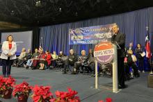 The bishop speaks from lectern. 