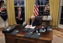 U.S. President Donald Trump signs an executive order in the Oval Office of the White House, in Washington on Jan. 23. (OSV News/Reuters/Carlos Barria)