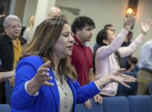 Guzman stands with hands raised outward. 