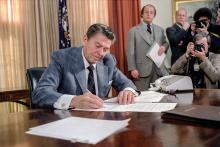 President Ronald Reagan signs an executive order on reductions in government spending in the Oval Office in the White House in Washington, D.C., on Jan. 22, 1981, two days after his inauguration. (U.S. National Archives and Records Administration)